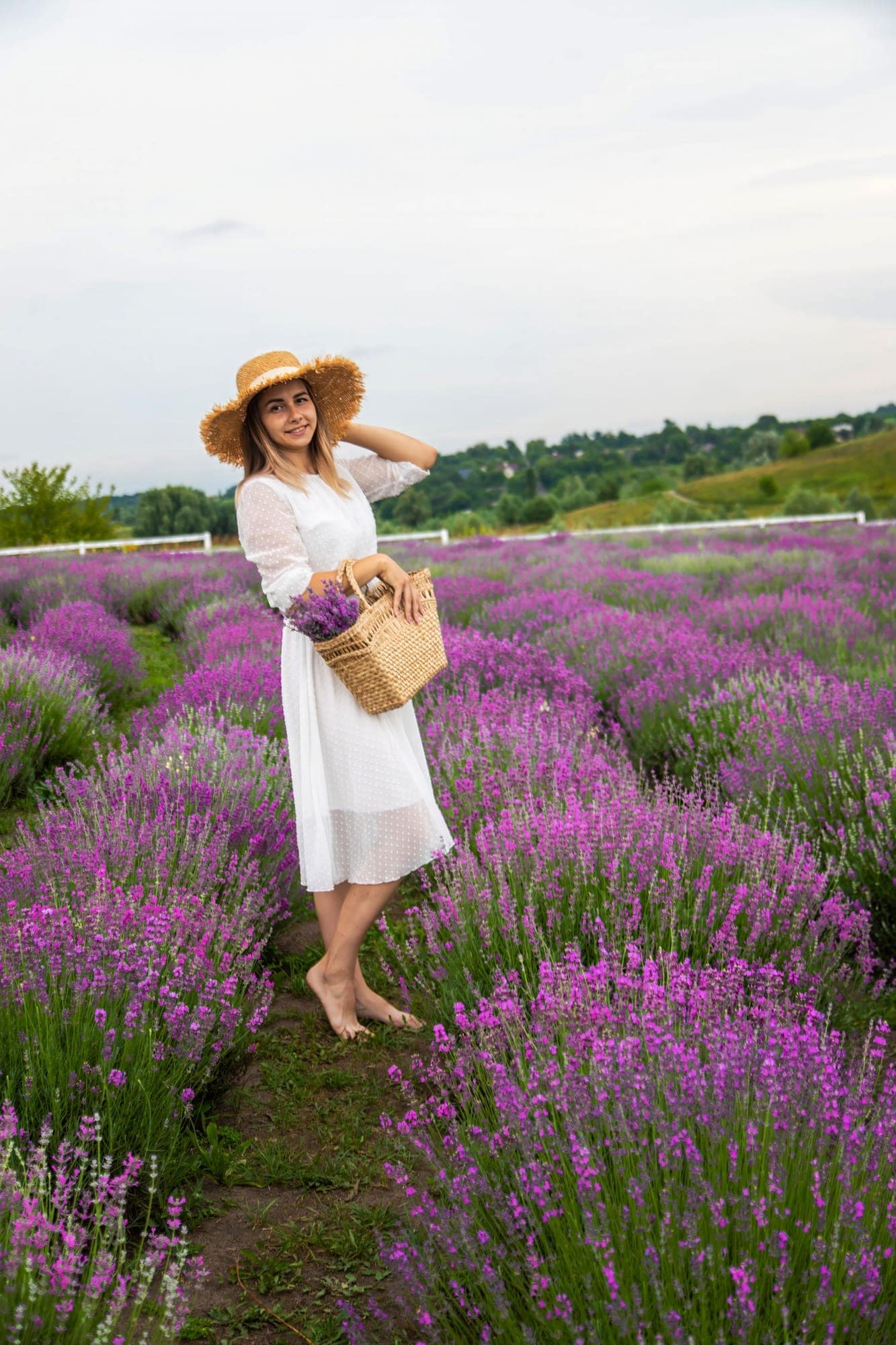 Start 15 Woman lavender field. Happy carefree woman in white dress walking through lavender field.